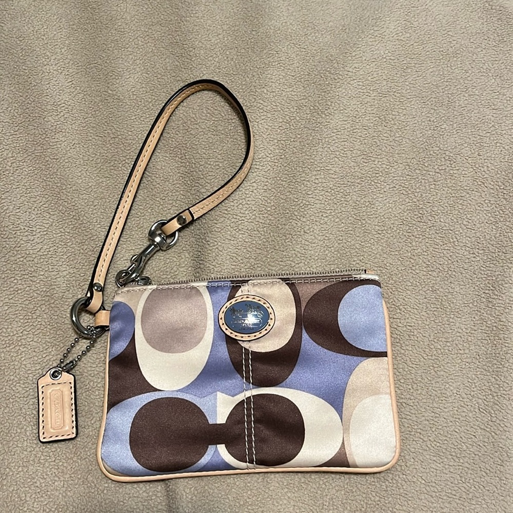 Coach corner zip wristlet. 6“ x 4“. Shades of blues and browns. VGUC